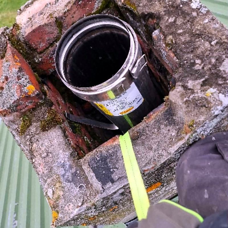 Ny pipe i gammel murpipe. Stålpipa senkes ned fra taket.